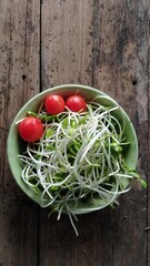 sunflower sprout in green ceranic blow  on old wood table kitchen
