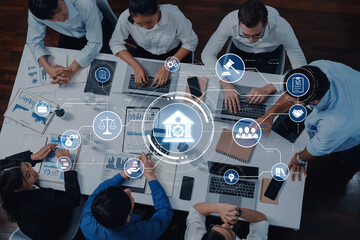 A diverse business team collaborates in an office space, utilizing technology and data-driven graphics to enhance decision-making and strategy formulation. Trope