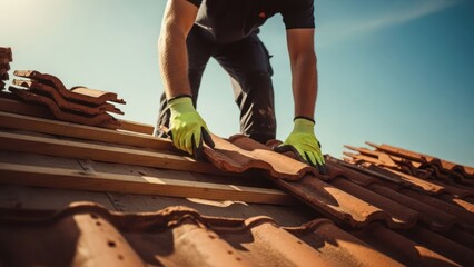 Roofer laying terracotta tiles, blue sky backdrop
