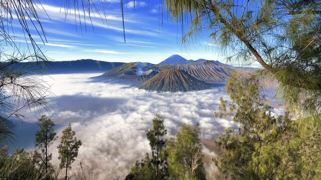 Eruption of the Bromo volcano during sunrise in the Bromo-Tengger-Semeru National Park, East Java, Indonesia. The Tengger volcanic caldera is in cloud and fog. Dawn. 4К