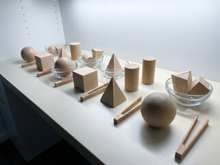 Wooden geometric shapes displayed on a table for learning