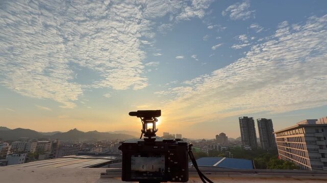 A camera on the rooftop of an apartment building in Shenzhen, Guangdong Province, China, is capturing a time-lapse video, while a mobile phone is recording the screen of the mirrorless camera that is 