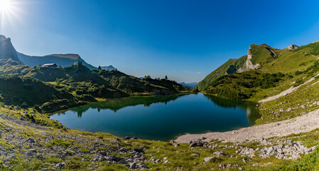 Serene Mountain Lake Reflection Captures Tranquil Beauty in Tannheimer Valleys Hidden Paradise