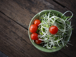 sunflower sprout in green ceranic blow  on old wood table kitchen