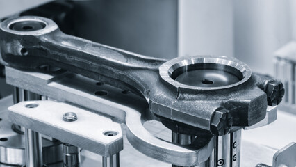 Testing the quality of repair of a car engine piston connecting rod, auto repair service concept background
