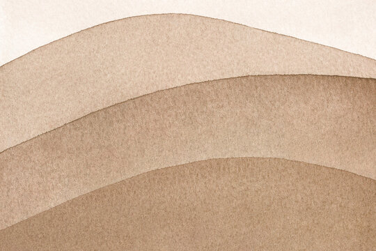 Abstract art hand drawn watercolor brown wavy desert sand background on textured watercolor paper for wallpaper banner template page design.