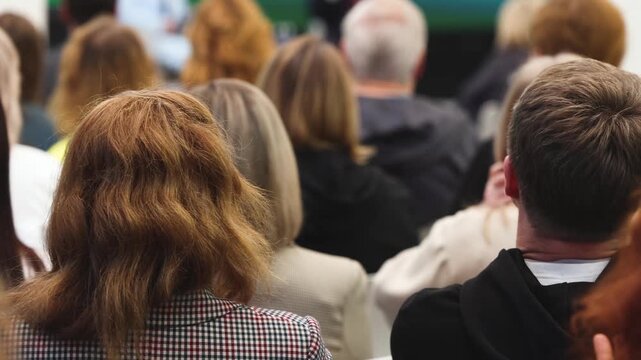 Audience at the modern conference hall listens to panel discussion, people on a congress together listen to speaker on stage at convention, plenary session at business seminar, venue for presentation