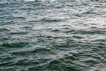 Close-up view of ocean water surface with gentle waves. Natural sea texture background representing calmness, motion, and marine environment.