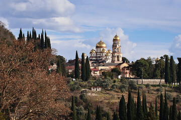 Obraz premium Panoramic view of New Athos Monastery in Abkhazia. Majestic Orthodox architecture surrounded by green hills and mountains, capturing spiritual heritage, scenic landscape and a famous Caucasus landmark