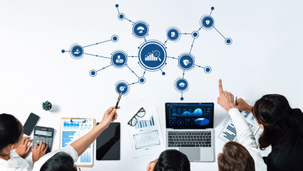 A professional management team collaborates to analyze data trends using advanced technology, focusing on business strategy and growth solutions in a dynamic work environment. Amity