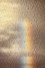 Woodchip wallpaper texture closeup with rainbow reflection background