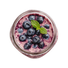 Top view of creamy blueberry yogurt dessert served in a glass jar with mint isolated on transparent background  