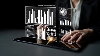 A business professional engages in data analysis on a tablet, utilizing modern visual aids for strategic marketing planning and effective business decisions. Impute