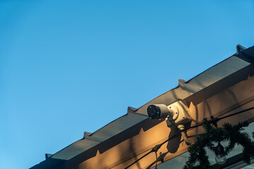 Security Camera on Rooftop Beneath Sky