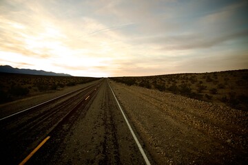 desert road into the sunset