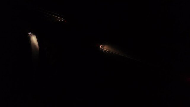 Aerial Night View of Moving Cars with Light Trails on Highway Interchange