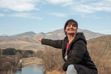 Girl against the backdrop of an autumn landscape in the mountains