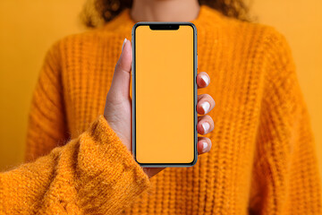 Mockup of female hand holding cell phone with blank screen