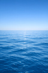 Fototapeta premium Calm Blue Ocean Surface under Clear Sky