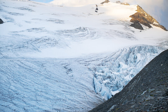 Alpine glacier with deep crevasses and ice flow in the Alps