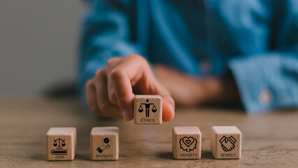 Code of conduct in business concept. Wooden blocks with code of conduct icons; code, integrity,...