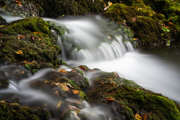 Cascades on Krupa river with mossy boulders, silky water in long exposure, calming scene