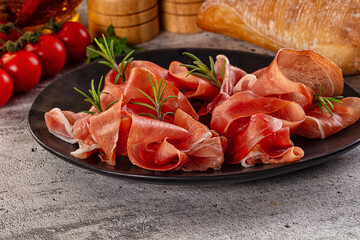 Spanish dry jamon serrano pork meat slices