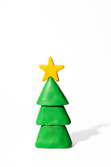 Plasticine Christmas tree with a star on top on a white background.
