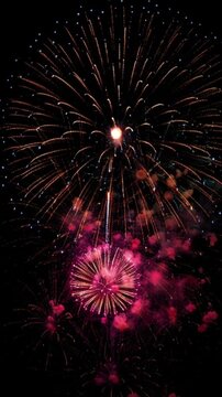 Spectacular fireworks display in vertical 9:16 format, bright colorful bursts for festive events, New Year party backgrounds, and celebratory holiday messages for mobile screens.