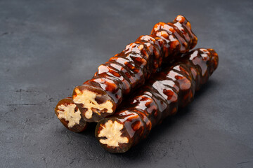 Walnut sausage dessert made with grape molasses and walnuts. Walnut sausage on black background