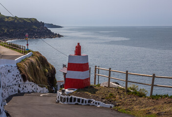 Volcanic natural swimming pools at Cinco Ribeiras on Terceira Island, Azores, Portugal. Black lava rocks, Atlantic Ocean waves and coastal bathing area under clear summer light