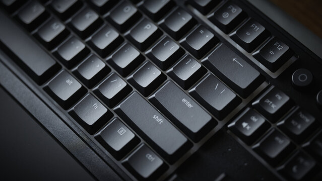 Close-up of Enter and Shift keys on a mechanical gaming keyboard with vibrant green RGB backlight
