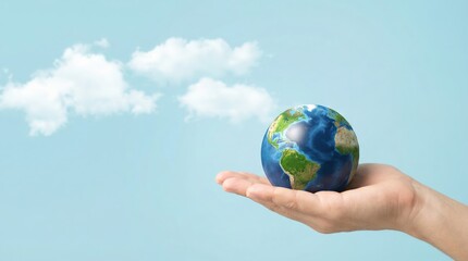 Hand holding a small globe representing Earth, surrounded by soft clouds against a blue sky, symbolizing environmental awareness and sustainability for Earth Day celebration