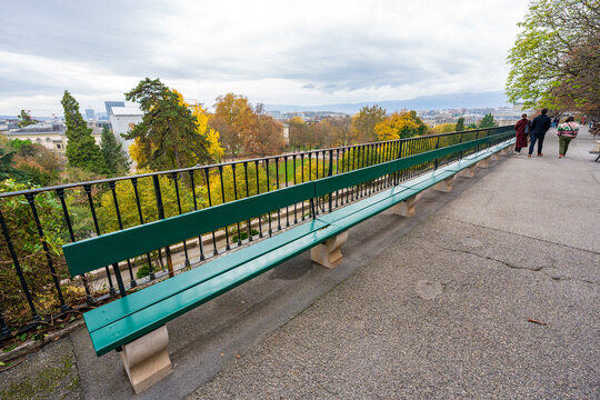 Promenade de la Treille longest wooden bench with autumn view. Geneva, Switzerland.