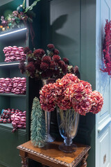 Fototapeta premium holiday floral arrangements and ornaments displayed on a wooden table