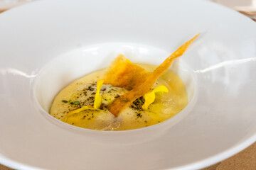 Elegant gourmet dish served in a modern white bowl, close-up shot