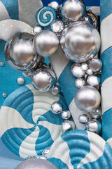 Festive New Year decoration with silver balls on a turquoise and white background.