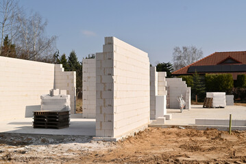 Aerated concrete block walls under construction for a new residential house on a sunny day.