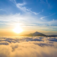 Sunrise over a mountain range shrouded in clouds