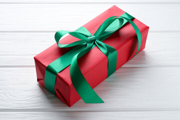 Beautiful gift box on white wooden table, closeup