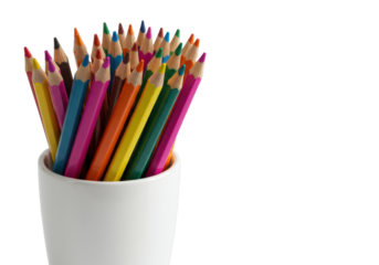 New rainbow colored pencils sharpened to a point in a white ceramic cup on a high-key studio background with copy space. Concept of creativity and inspiration.