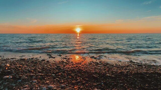 Orange sunset in Tuapse, sea waves with foam run to the shore. The Black Sea coast at sunset in the clouds. Pebble beach in the village of Agoy. The stormy sea in the evening. 4К