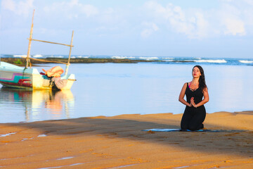 Woman Meditating on a Serene Beach at Sunrise