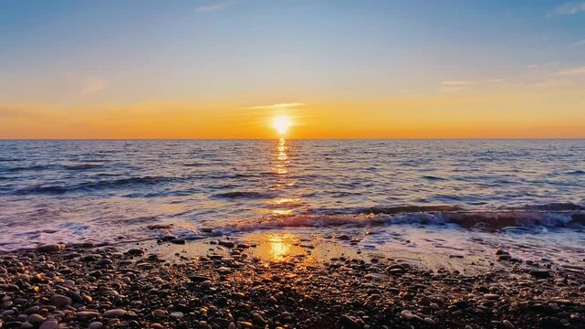 Orange sunset in Tuapse, sea waves with foam run to the shore. The Black Sea coast at sunset in the clouds. Pebble beach in the village of Agoy. The stormy sea in the evening. 4К