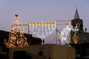 Beautiful decorations representing the three major religions in Wadi Nisnas the Christian neighborhood in Haifa, Israel. a Christmas tree, Hanukkiah and moon and cresent.
