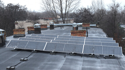 Solar panels on a roof in cloudy weather with the first snow 7 kW capacity