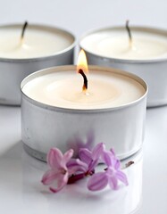 Three tea light candles and flowers