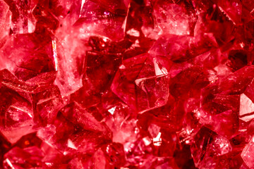 Amethyst red crystals. Gems. Mineral crystals in the natural environment. Texture of precious and semiprecious stones. Seamless background with copy space colored shiny surface of precious stones.