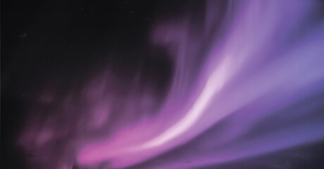 Majestic violet and lavender aurora sweeping upward in a graceful arc, fanning across the black...