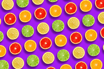 Pattern of sliced citrus fruits on purple background